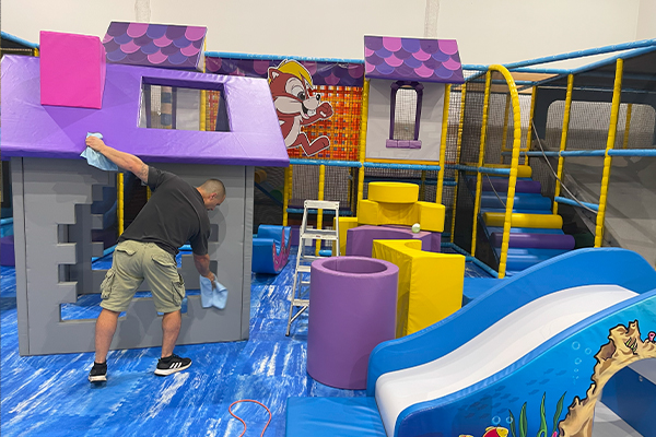 Cleaning indoor playground equipment in Wetherill Park, Sydney for a sanitized environment.